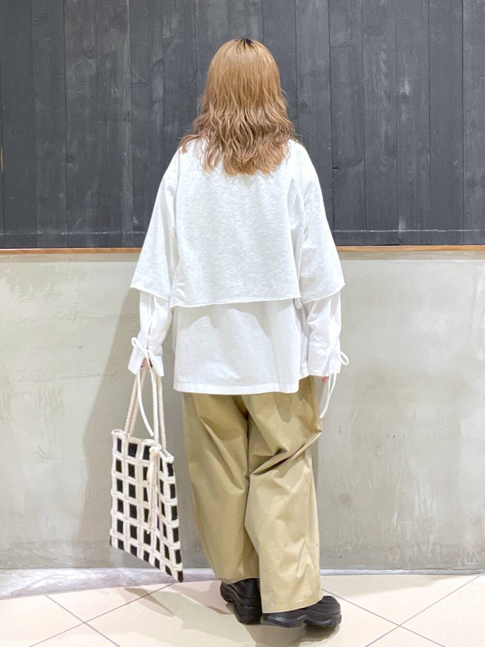ブラック系のローファー、ベージュ系のチノパンツ、ベージュ系のTシャツ/カットソーを着用したレディースの春コーディネートの3枚目の写真