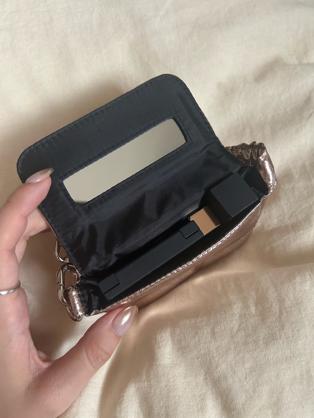 ゴールド系のポーチを着用したレディースの秋コーディネートの2枚目の写真