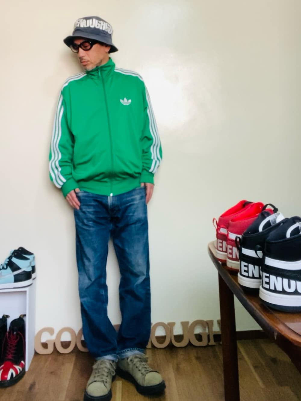 グリーン系のジャージ、ブルー系のデニムパンツ、グリーン系のスニーカーを着用したメンズの冬コーディネートの2枚目の写真