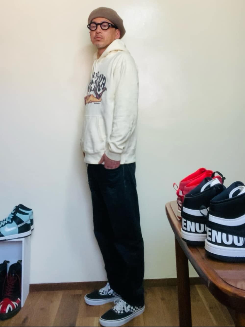 ベージュ系のパーカー、ブラック系のデニムパンツ、ブラック系のスニーカーを着用したメンズの春コーディネートの2枚目の写真