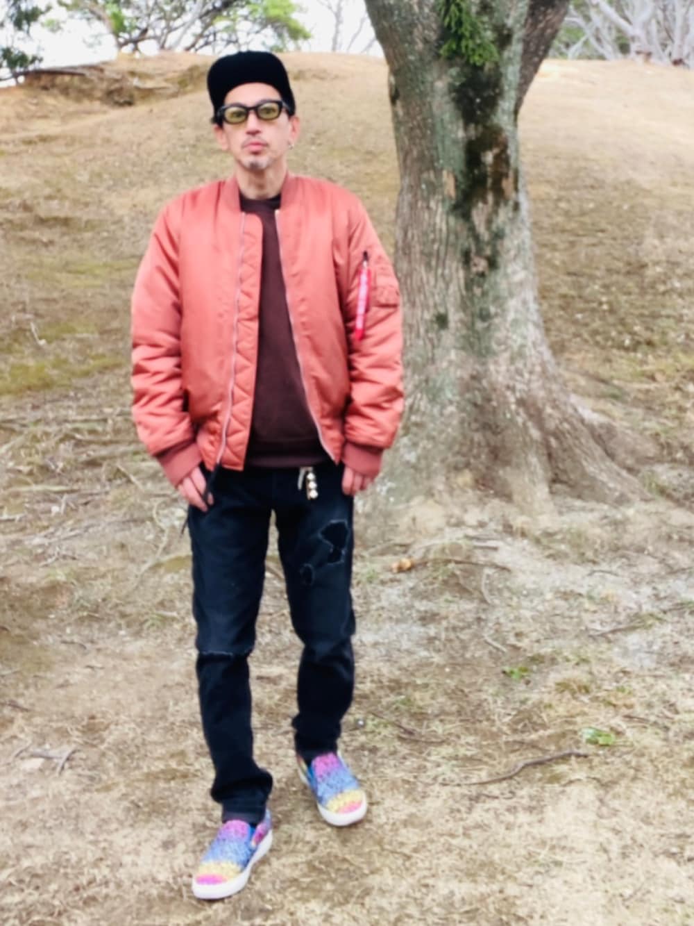 レッド系のMA-1、ブラウン系のスウェット、ブラック系のその他パンツを着用したメンズの冬コーディネートの5枚目の写真