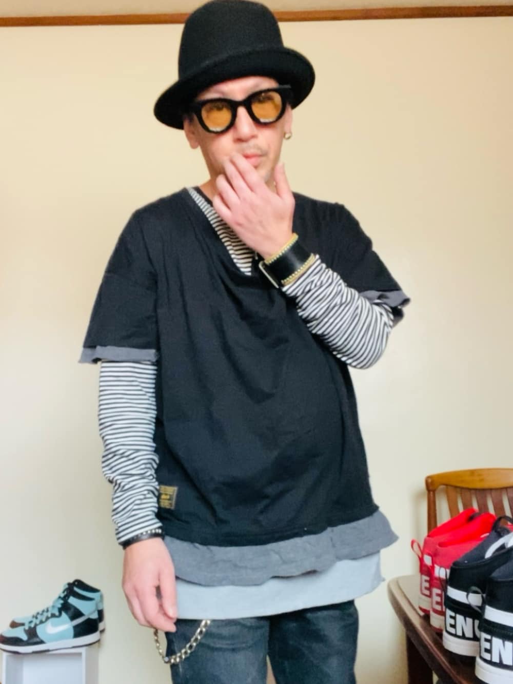 ブラック系のトップス、ブラック系のデニムパンツ、グリーン系のスニーカーを着用したメンズの春コーディネートの4枚目の写真