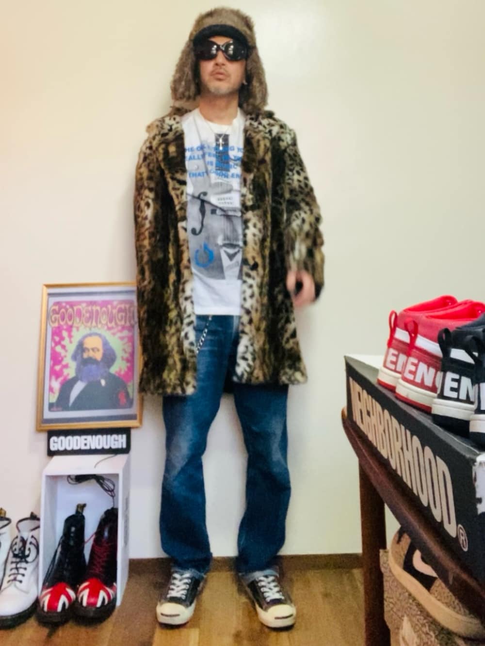 ブラウン系のムートンコート、ホワイト系のTシャツ/カットソー、ブルー系のデニムパンツを着用したメンズの冬コーディネートの5枚目の写真