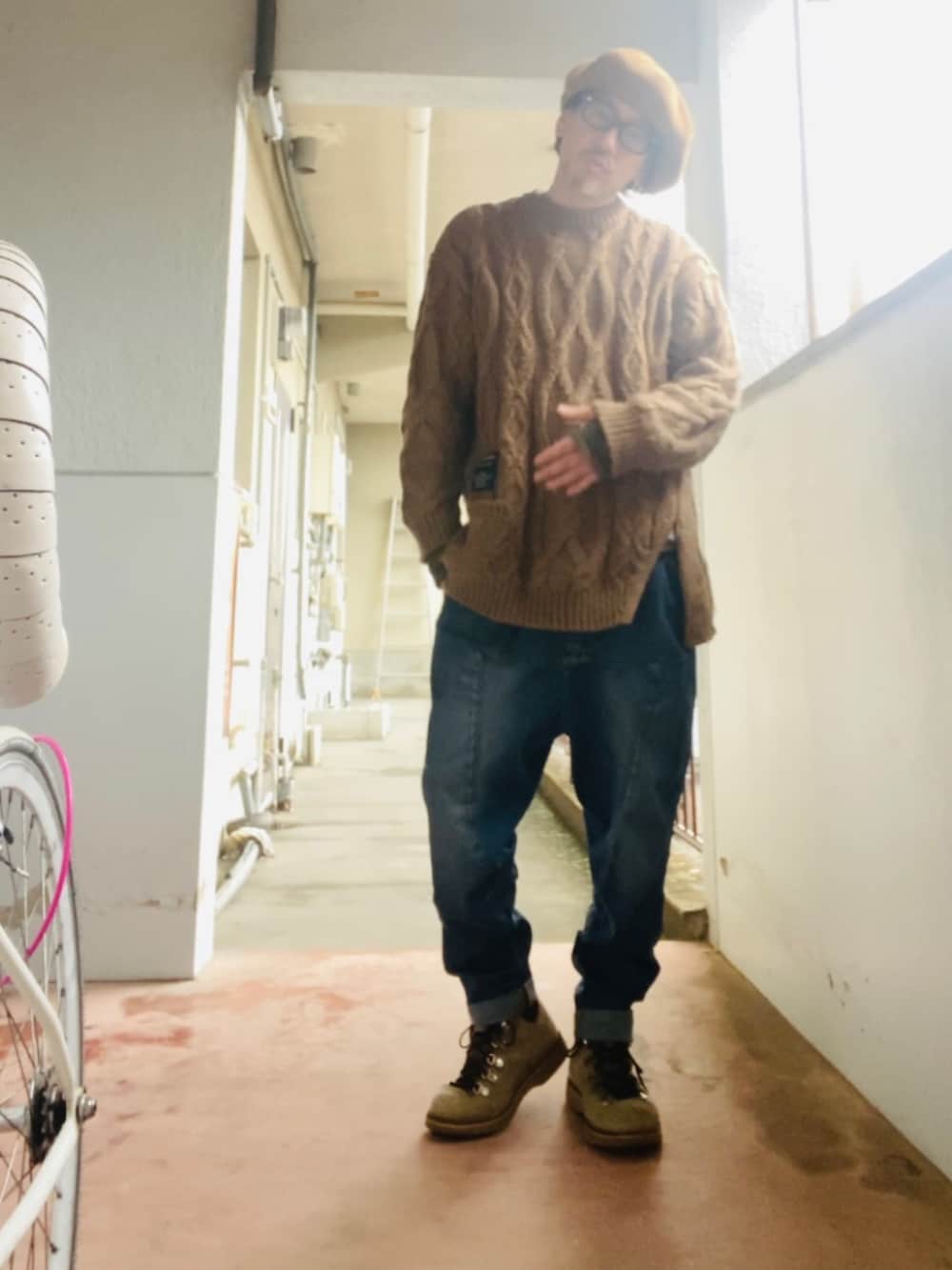 ブラウン系のニット/セーター、ブルー系のデニムパンツ、ベージュ系のブーツを着用したメンズの冬コーディネートの4枚目の写真