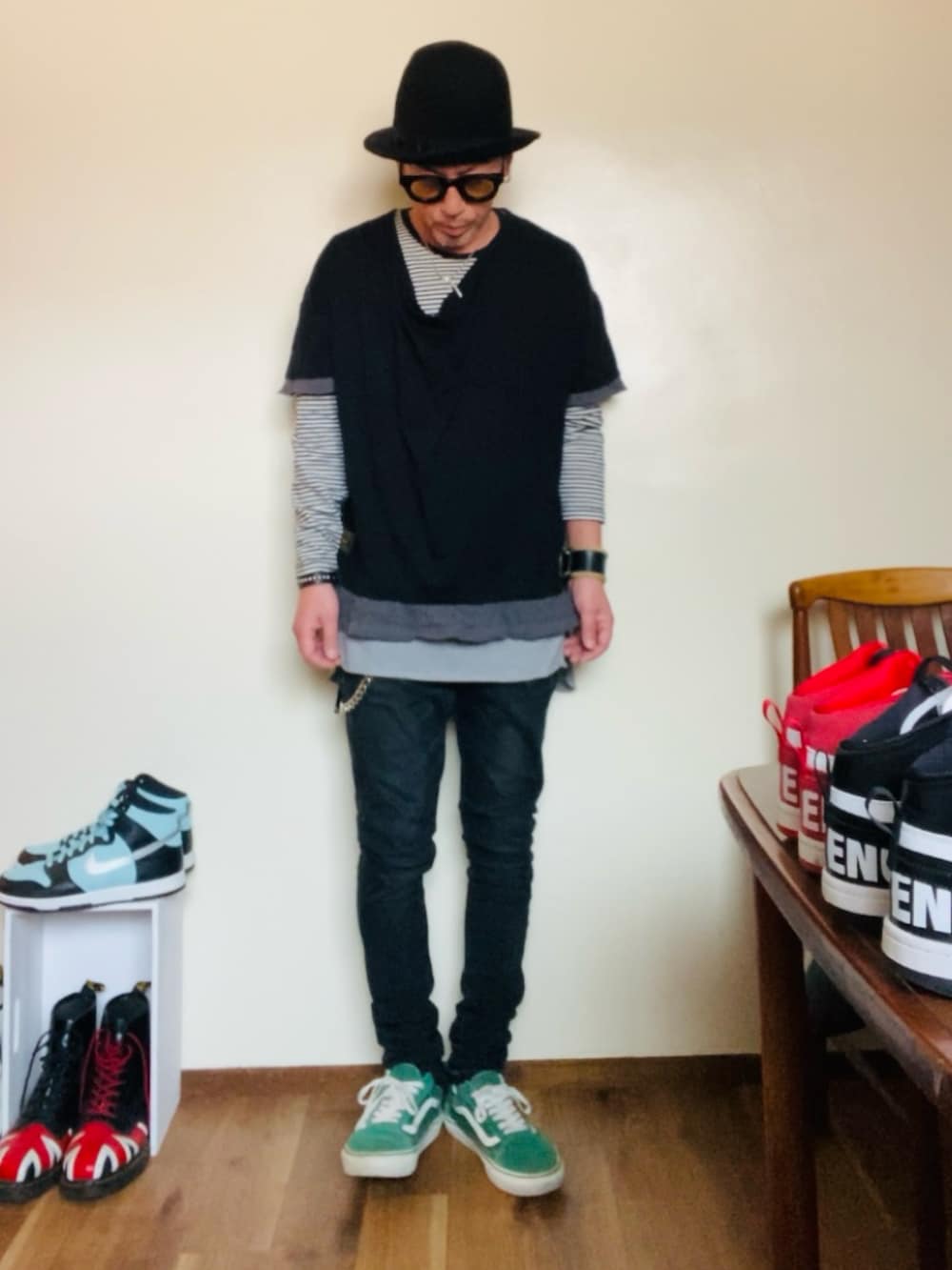 ブラック系のトップス、ブラック系のデニムパンツ、グリーン系のスニーカーを着用したメンズの春コーディネートの2枚目の写真