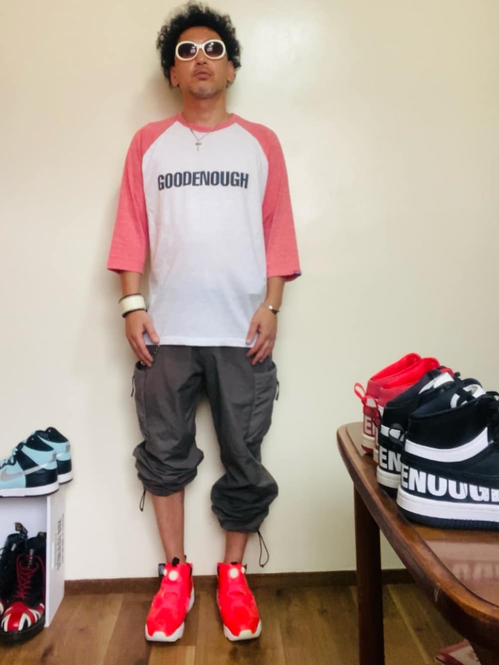 ピンク系のTシャツ/カットソー、グレー系のカーゴパンツ、ピンク系のスニーカーを着用したメンズの夏コーディネートの4枚目の写真