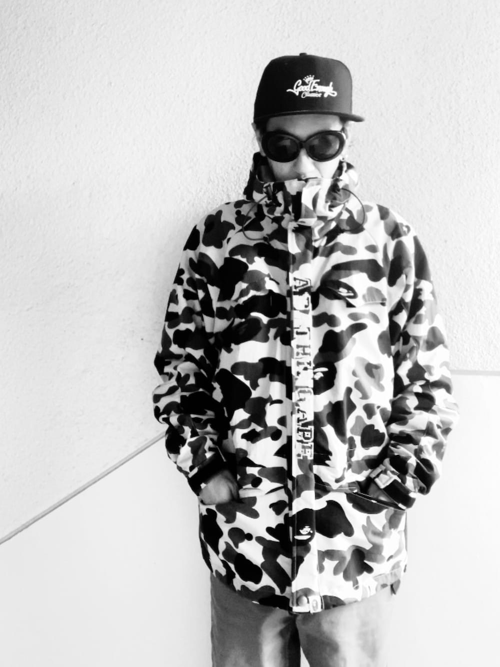 イエロー系のマウンテンパーカー、グリーン系のカーゴパンツ、ブラック系のブーツを着用したメンズの秋コーディネートの4枚目の写真