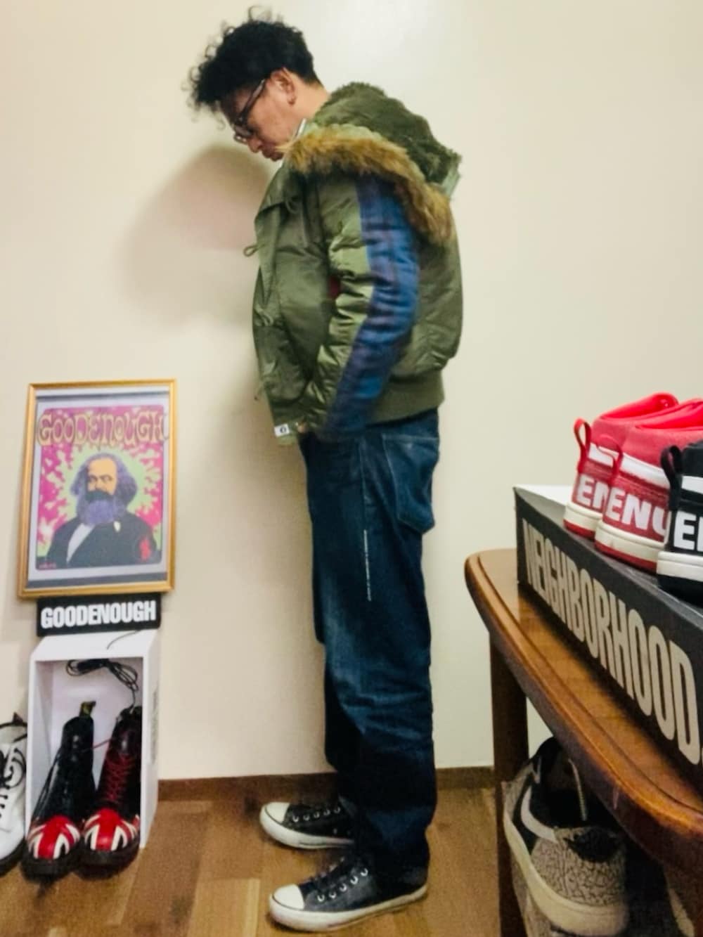 ブラック系のスウェット、グリーン系のMA-1、ブルー系のデニムパンツを着用したメンズの冬コーディネートの2枚目の写真