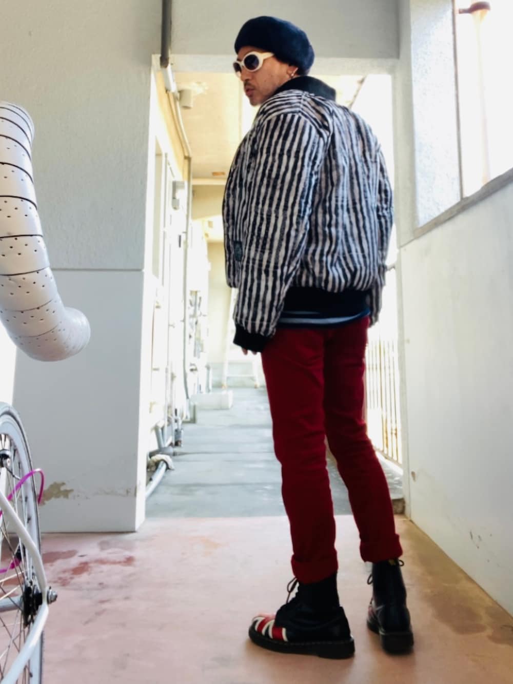 ブラック系のMA-1、ブラック系のタンクトップ、レッド系のデニムパンツを着用したメンズの秋コーディネートの3枚目の写真