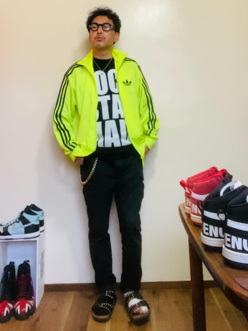 ブラック系のTシャツ/カットソー、イエロー系のジャージ、ブラック系のカーゴパンツを着用したメンズの春コーディネートの2枚目の写真
