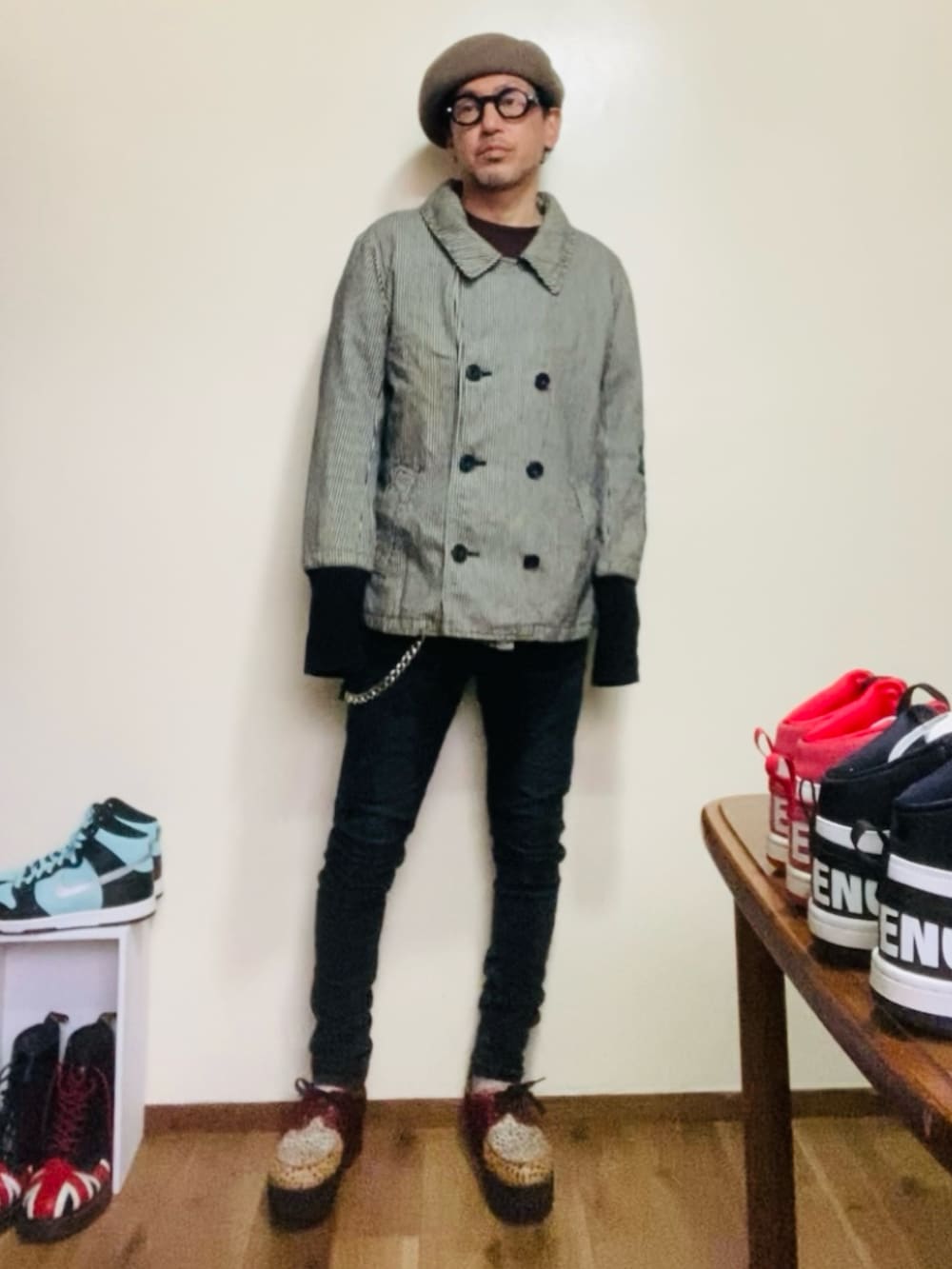 グレー系のピーコート、ブラック系のデニムパンツ、その他のシューズを着用したメンズの春コーディネートの2枚目の写真