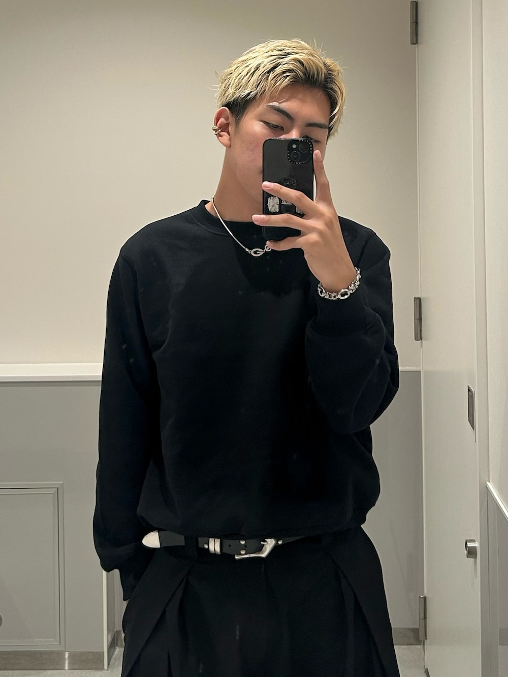 ホワイト系のタンクトップ、ブラック系のスウェット、ブラック系のスラックスを着用したメンズの秋コーディネートの2枚目の写真