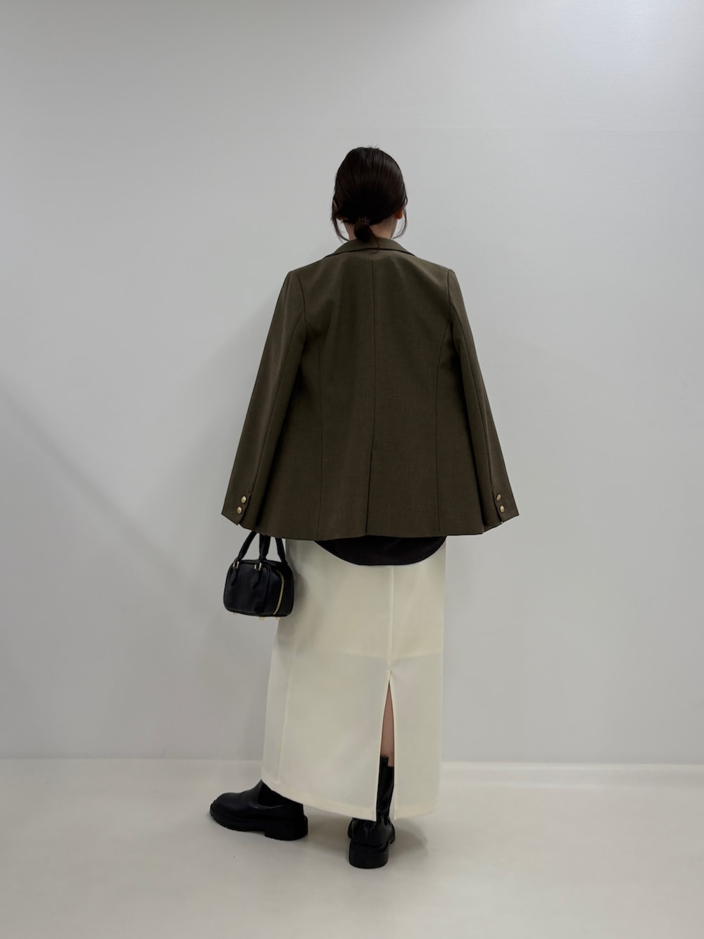 グレー系のシャツ/ブラウス、ブラウン系のテーラードジャケット、ホワイト系のスカートを着用したレディースの秋コーディネートの2枚目の写真