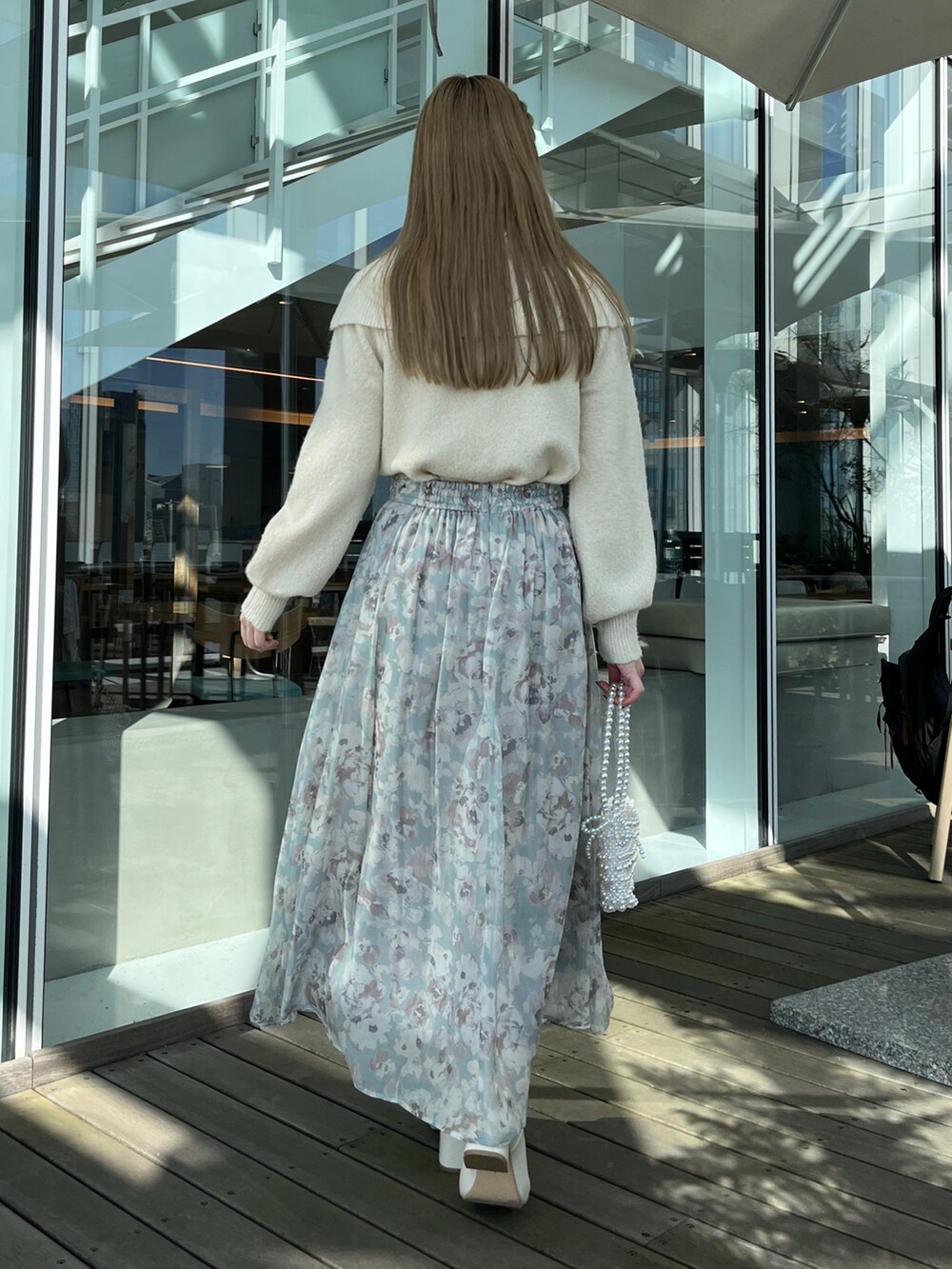 ホワイト系のニット/セーター、グリーン系のスカート、ホワイト系のショルダーバッグを着用したレディースの冬コーディネートの3枚目の写真