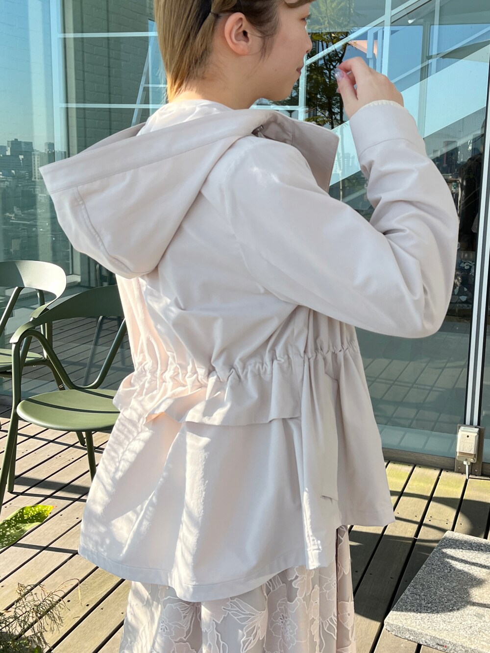 ベージュ系のブルゾン、ホワイト系のニット/セーター、ベージュ系のスカートを着用したレディースの冬コーディネートの3枚目の写真