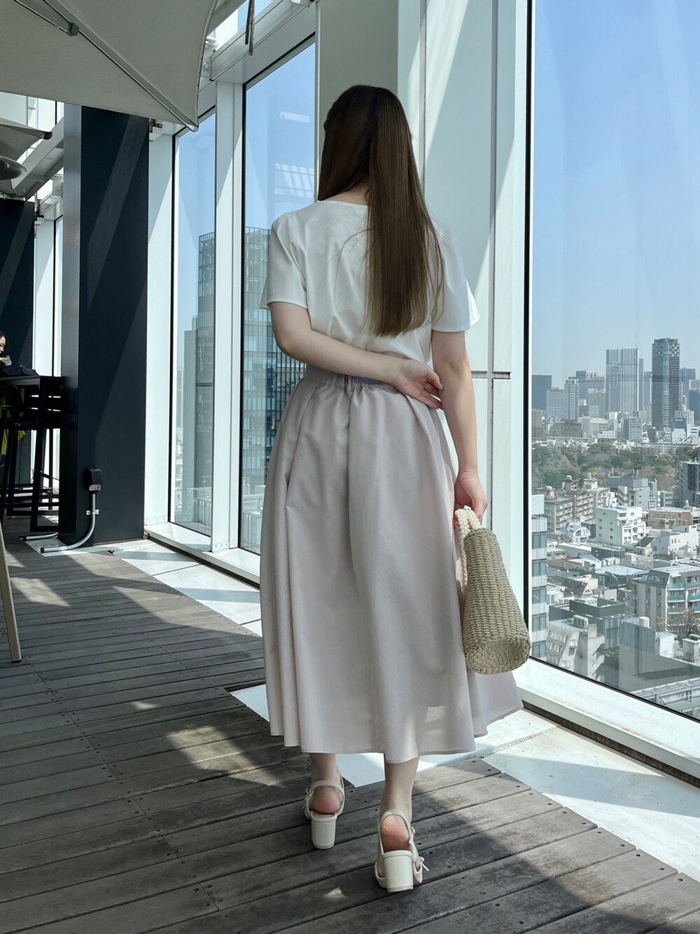 ホワイト系のTシャツ/カットソー、グレー系のスカートを着用したレディースの春コーディネートの3枚目の写真