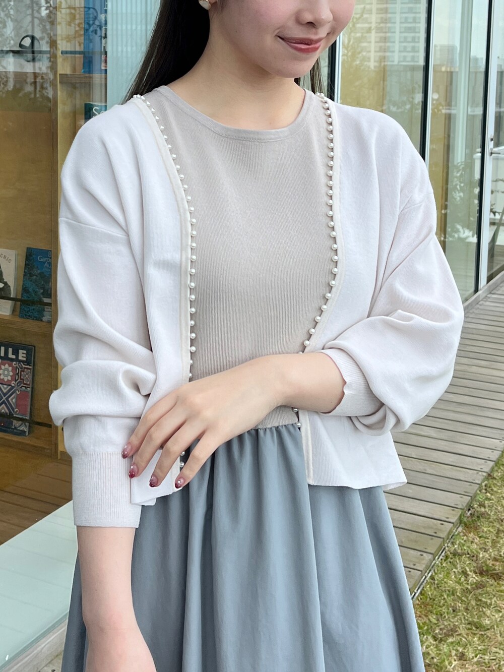 ホワイト系のカーディガン/ボレロ、ブルー系のワンピースを着用したレディースの春コーディネートの3枚目の写真