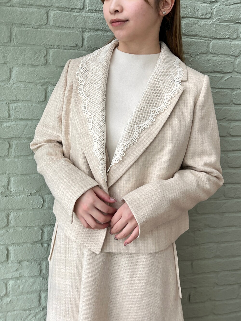 ベージュ系のテーラードジャケット、ベージュ系のワンピースを着用したレディースの春コーディネートの4枚目の写真