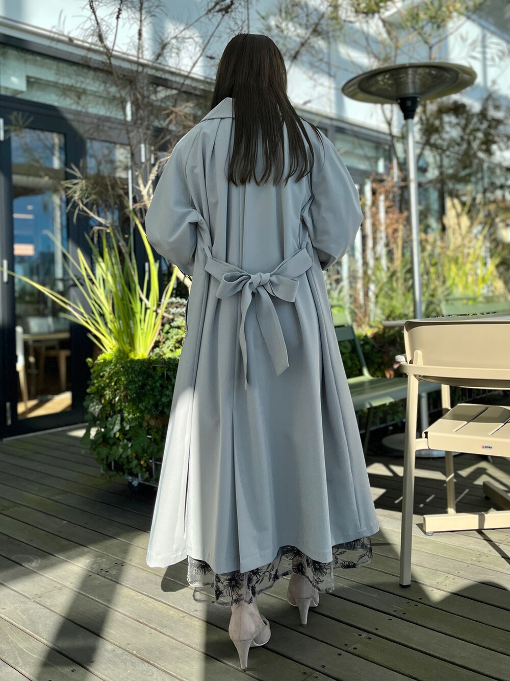 グレー系のトレンチコート、ブラック系のシャツ/ブラウス、ブラウン系のスカートを着用したレディースの冬コーディネートの3枚目の写真