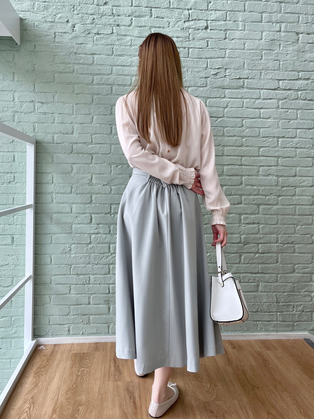 ホワイト系のシャツ/ブラウス、グリーン系のスカートを着用したレディースの春コーディネートの3枚目の写真