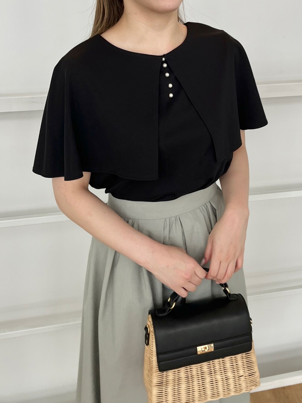 ブラック系のショルダーバッグ、ホワイト系のサンダル、ブラック系のTシャツ/カットソーを着用したレディースの夏コーディネートの4枚目の写真