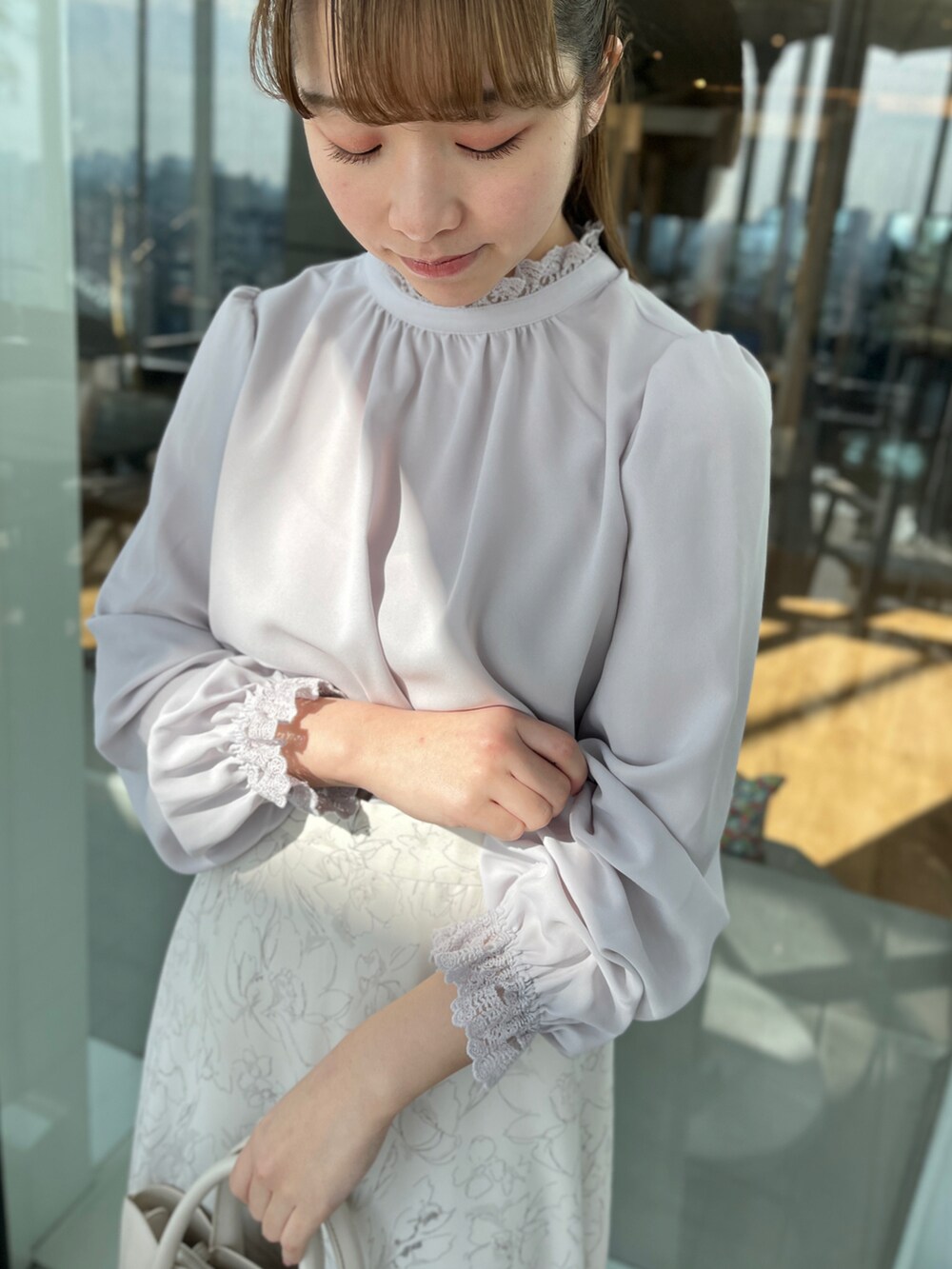 グレー系のシャツ/ブラウス、ベージュ系のスカート、ベージュ系のパンプスを着用したレディースの冬コーディネートの4枚目の写真