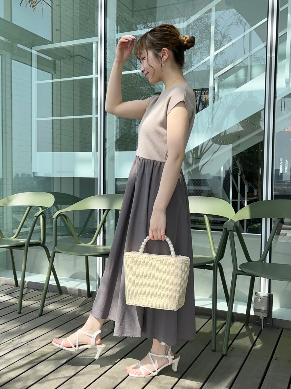 ブラウン系のワンピース、ベージュ系のハンドバッグ、ホワイト系のサンダルを着用したレディースの春コーディネートの2枚目の写真