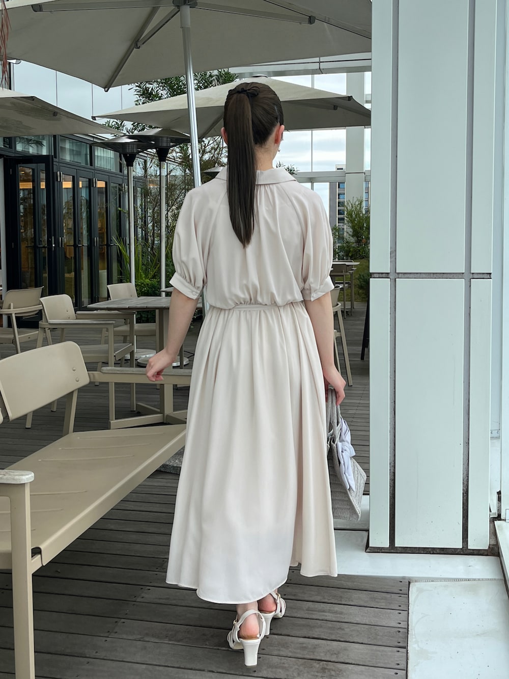 ホワイト系のワンピース、グレー系のトートバッグ、ホワイト系のサンダルを着用したレディースの夏コーディネートの3枚目の写真