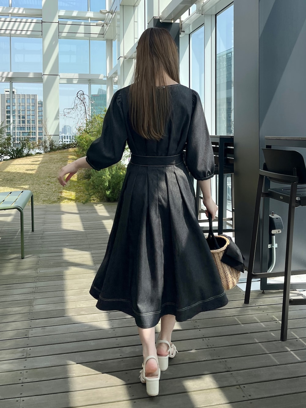 ブラック系のワンピースを着用したレディースの春コーディネートの3枚目の写真