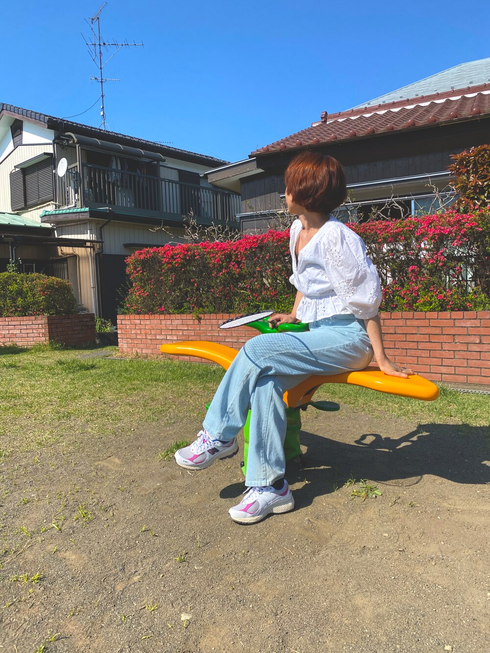 ホワイト系のシャツ/ブラウス、ブルー系のデニムパンツ、ホワイト系のスニーカーを着用したレディースの春コーディネートの2枚目の写真