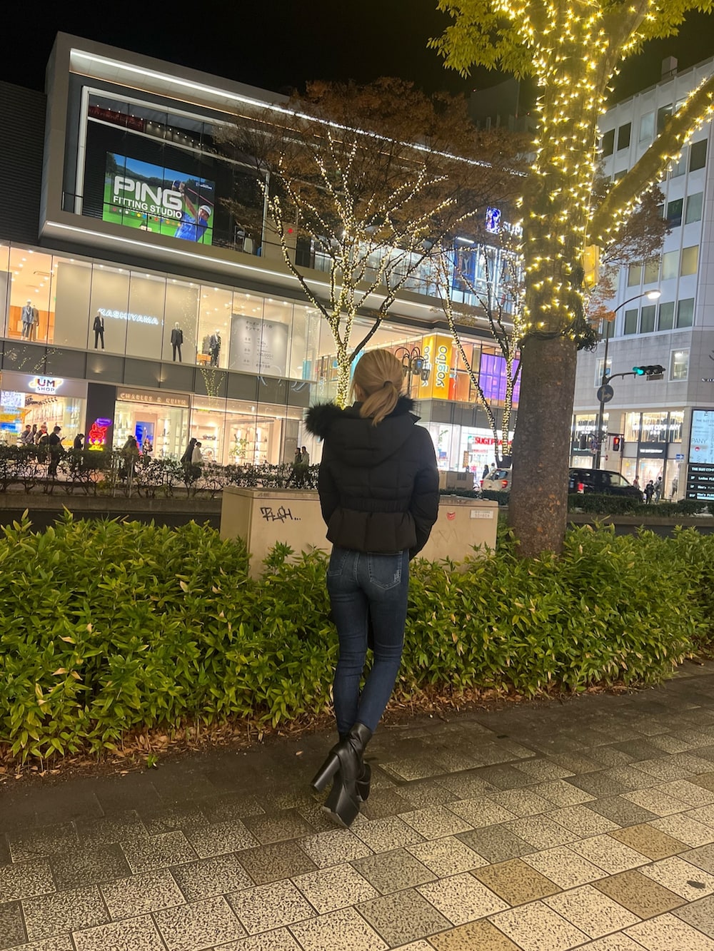 ブラック系のダウンジャケット/コート、ブルー系のデニムパンツ、ブラック系のブーツを着用したレディースの秋コーディネートの6枚目の写真