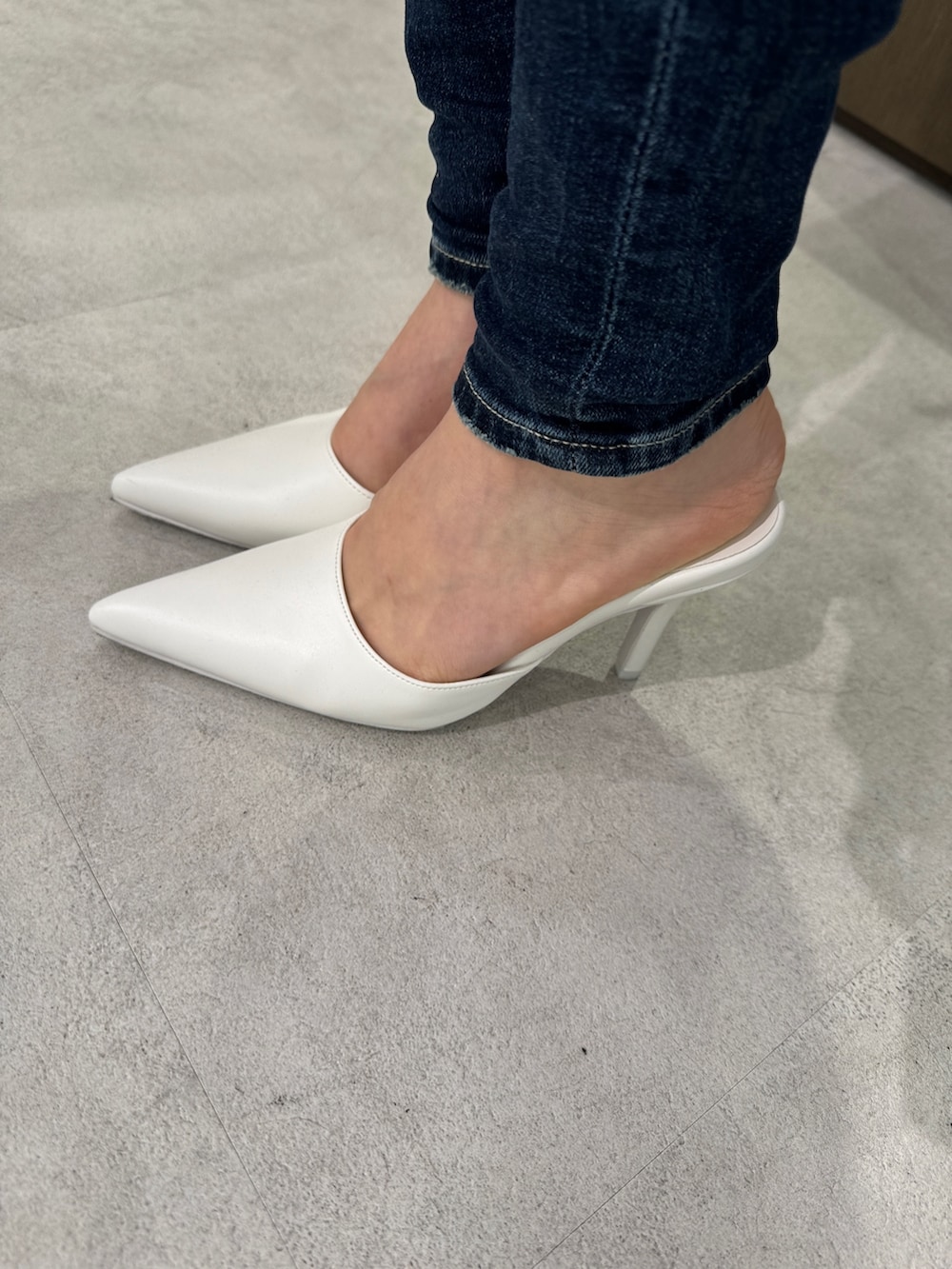 その他のキャミソール、ブルー系のデニムパンツ、ホワイト系のパンプスを着用したレディースの春コーディネートの7枚目の写真