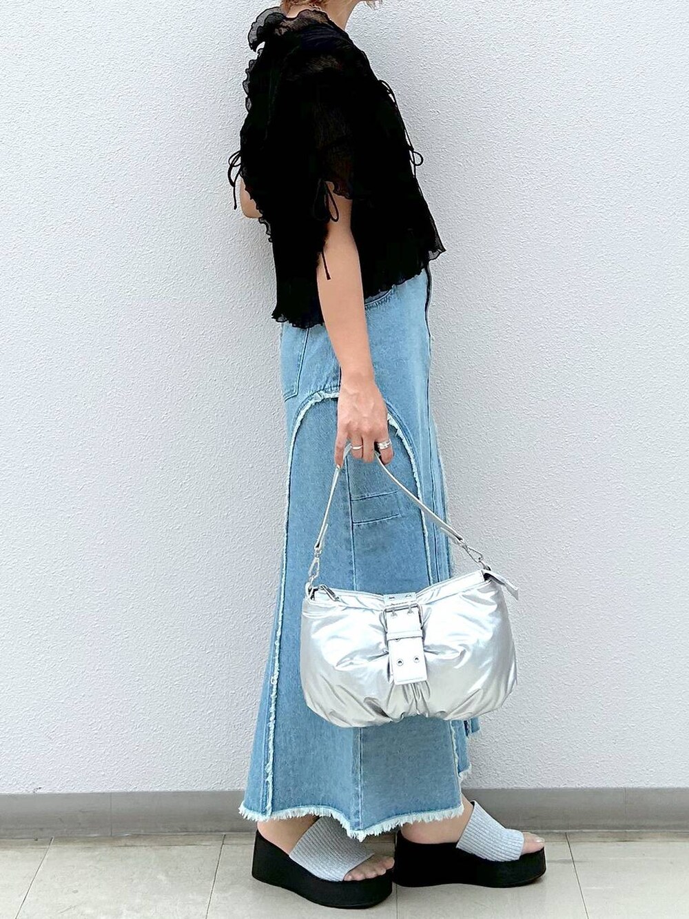 シルバー系のサンダル、シルバー系のショルダーバッグ、ブラック系のキャミソールを着用したレディースの夏コーディネートの4枚目の写真