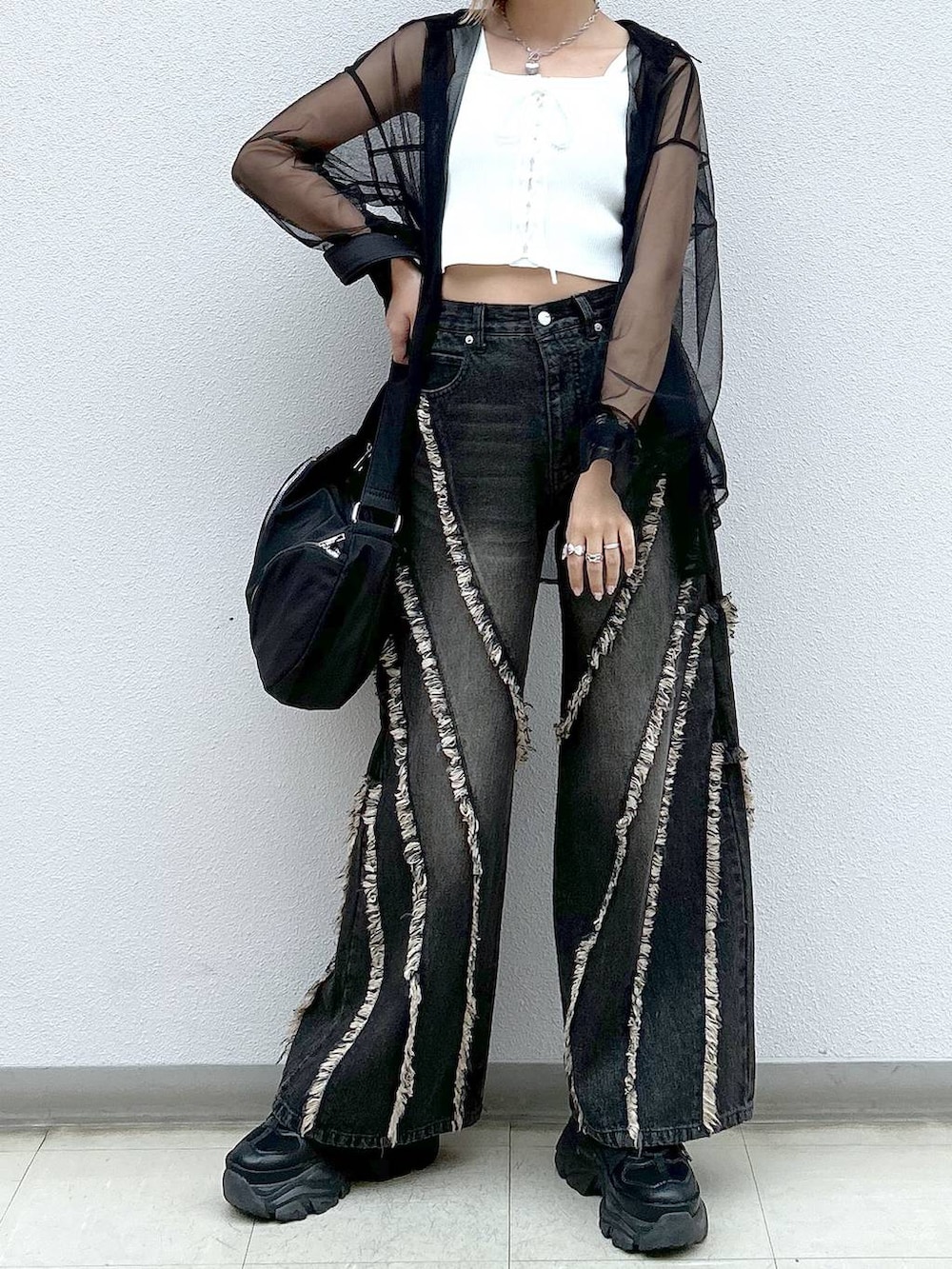 ブラック系のスニーカー、ホワイト系のタンクトップ、ブラック系のシャツ/ブラウスを着用したレディースの夏コーディネートの4枚目の写真