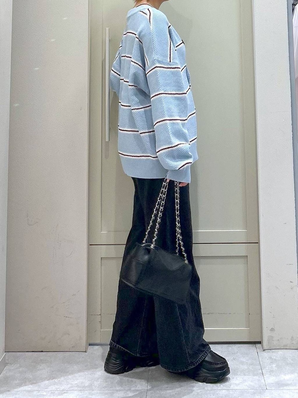 ブラック系のデニムパンツ、ブラック系のショルダーバッグ、ブラック系のローファーを着用したレディースの冬コーディネートの5枚目の写真