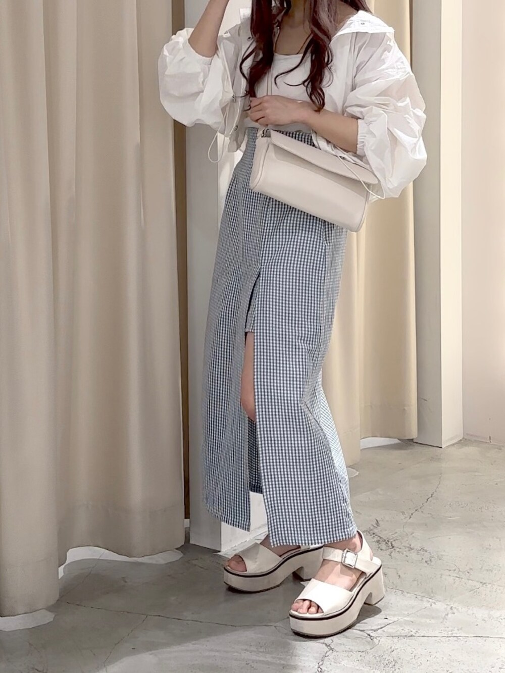 ホワイト系のマウンテンパーカー、ホワイト系のキャミソール、ホワイト系のボディバッグ/ウエストポーチを着用したレディースの春コーディネートの3枚目の写真