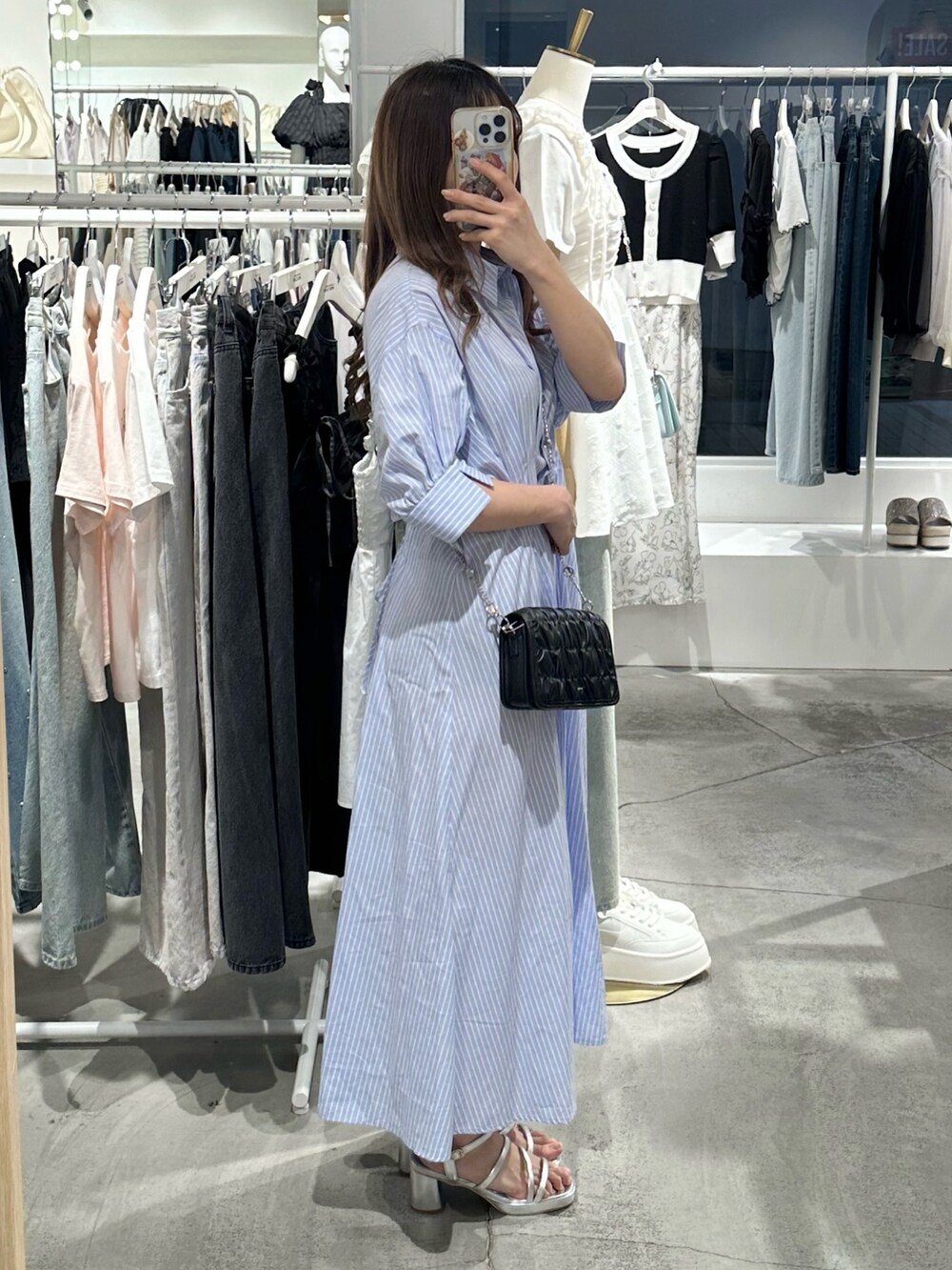 ブルー系のワンピース、ブラック系のショルダーバッグ、シルバー系のシューズを着用したレディースの夏コーディネートの5枚目の写真