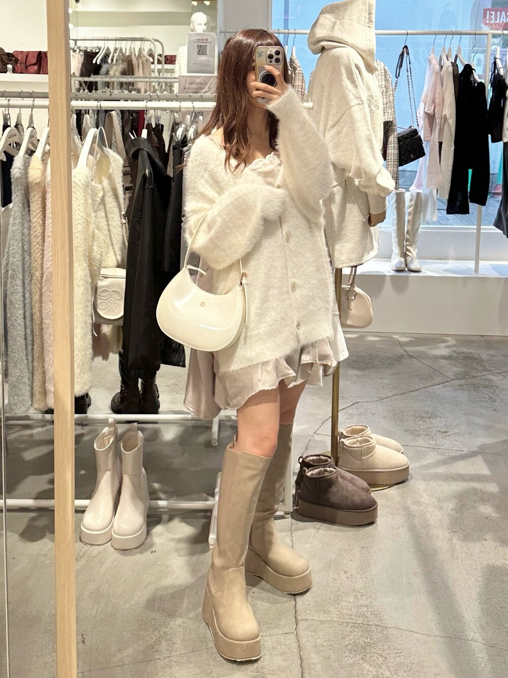 ホワイト系のカーディガン/ボレロ、ベージュ系のブーツ、ホワイト系のショルダーバッグを着用したレディースの秋コーディネートの8枚目の写真