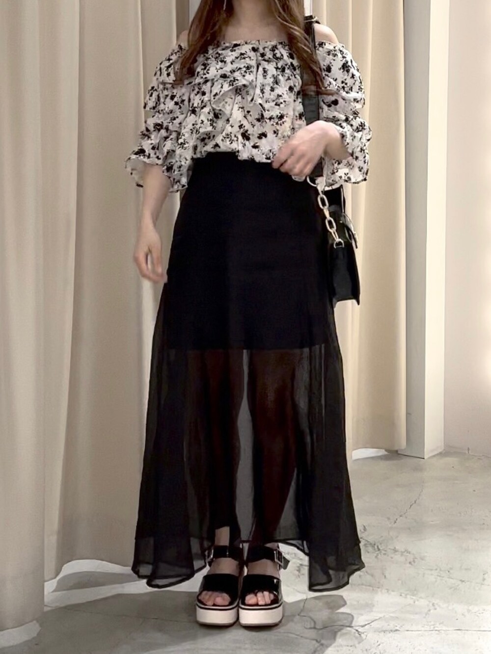 ブラック系のシャツ/ブラウス、ブラック系のスカート、ブラック系のショルダーバッグを着用したレディースの春コーディネートの3枚目の写真