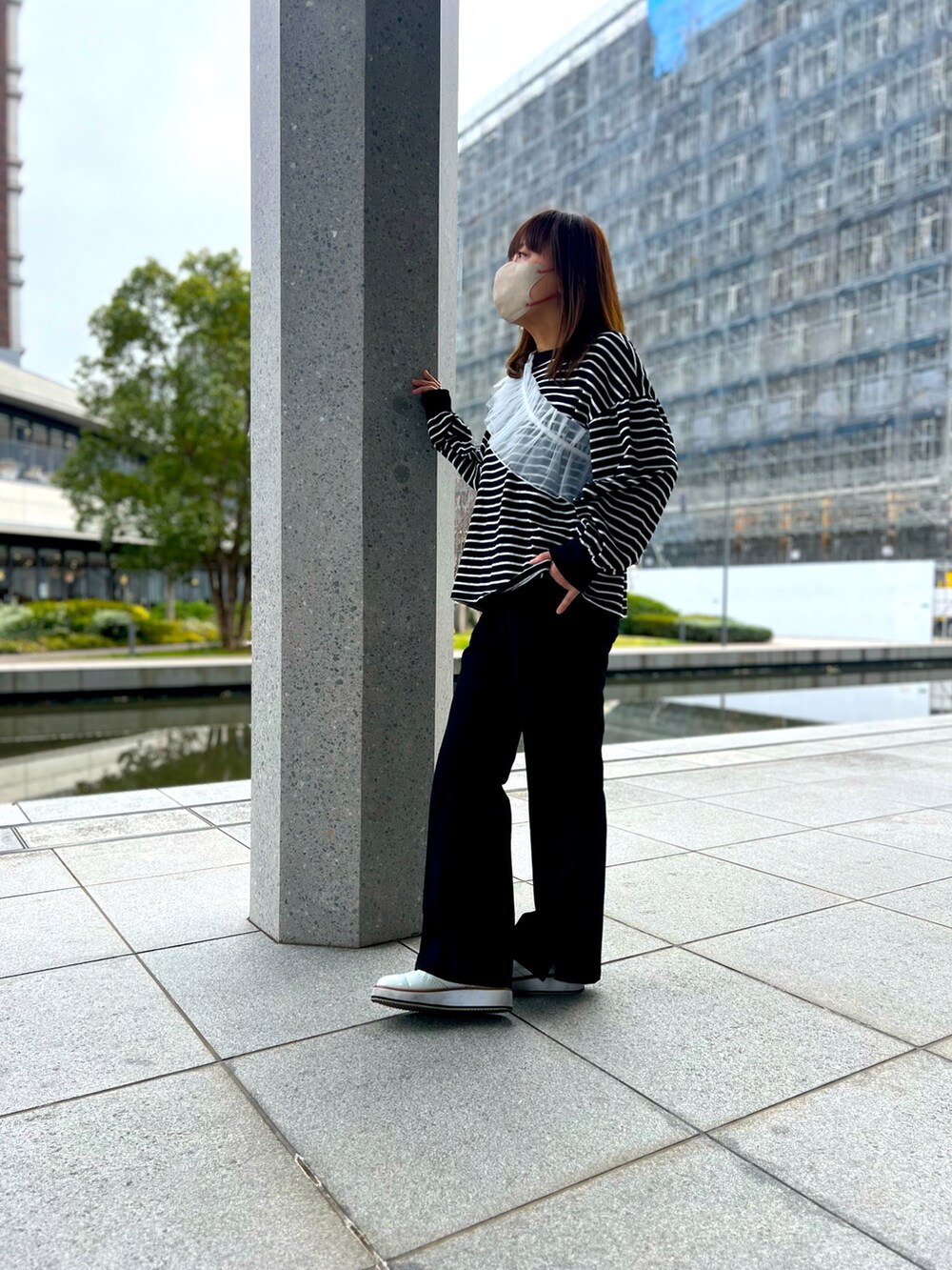 ブラック系のTシャツ/カットソー、ブラック系のその他パンツ、ホワイト系のローファーを着用したレディースの春コーディネートの3枚目の写真