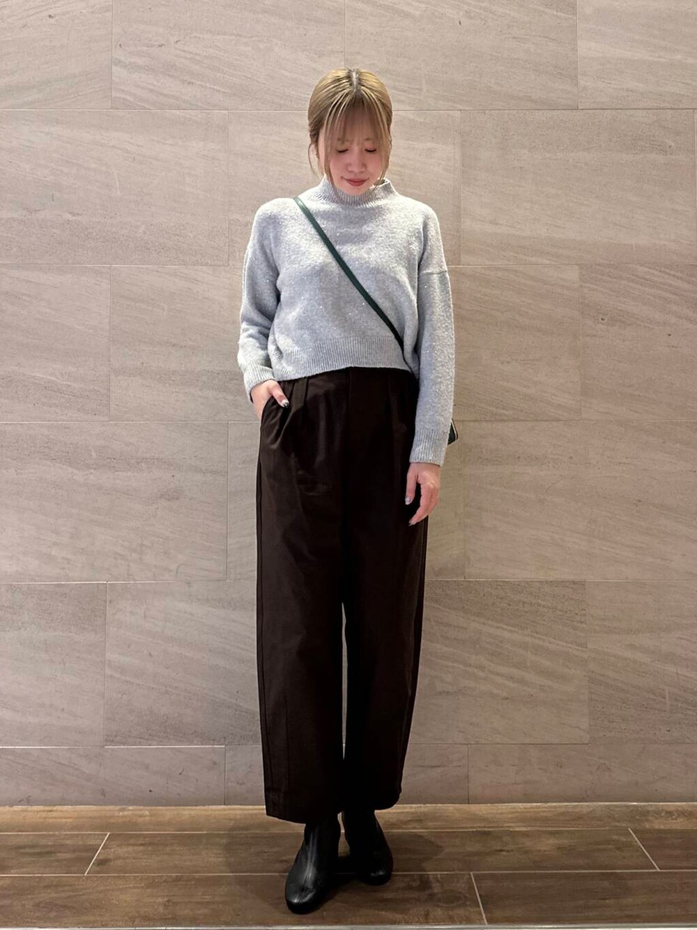 ブラック系のブーツ、グリーン系のショルダーバッグ、グレー系のニット/セーターを着用したレディースの秋コーディネートの3枚目の写真