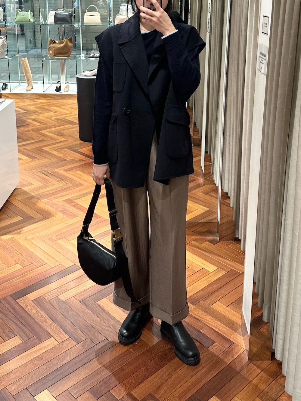 ブルー系のニット/セーター、ブラウン系のその他パンツ、ブルー系のその他アウターを着用したレディースの冬コーディネートの2枚目の写真