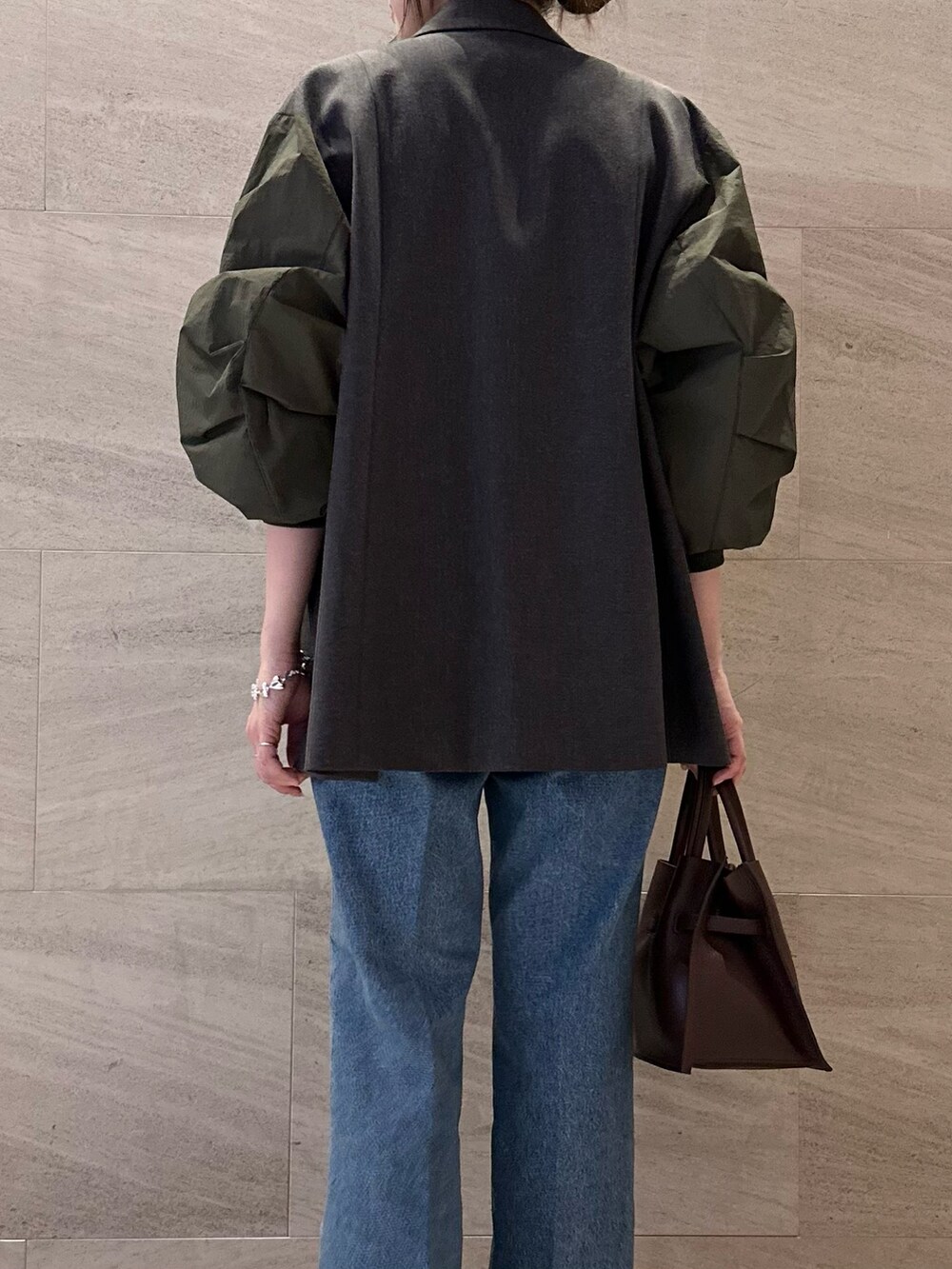 グレー系のその他アウター、ホワイト系のその他トップス、ブルー系のデニムパンツを着用したレディースの秋コーディネートの5枚目の写真