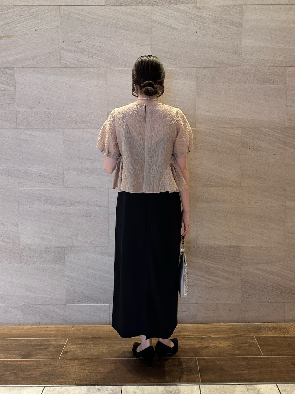 ベージュ系のその他アウター、ブラック系のパンプス、シルバー系のハンドバッグを着用したレディースの秋コーディネートの3枚目の写真
