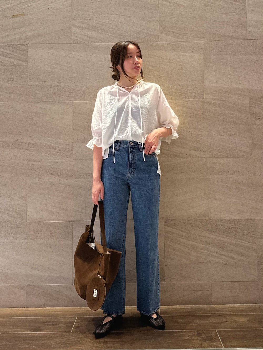 ホワイト系のシャツ/ブラウス、ブルー系のデニムパンツ、ブラウン系のトートバッグを着用したレディースの夏コーディネートの3枚目の写真