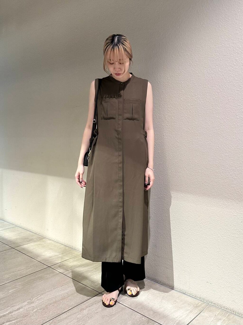 ブラック系のショルダーバッグ、ブラウン系のサンダル、ブラック系のその他パンツを着用したレディースの夏コーディネートの2枚目の写真