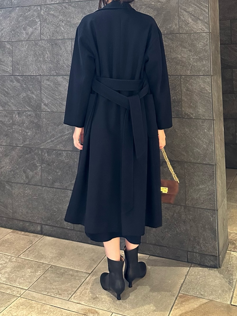 ブルー系のワンピース、ブラック系のその他アウター、ブラウン系のショルダーバッグを着用したレディースの秋コーディネートの3枚目の写真