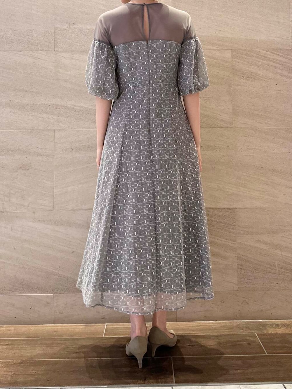 ブラウン系のパンプス、シルバー系のハンドバッグ、グレー系のワンピースを着用したレディースの春コーディネートの5枚目の写真