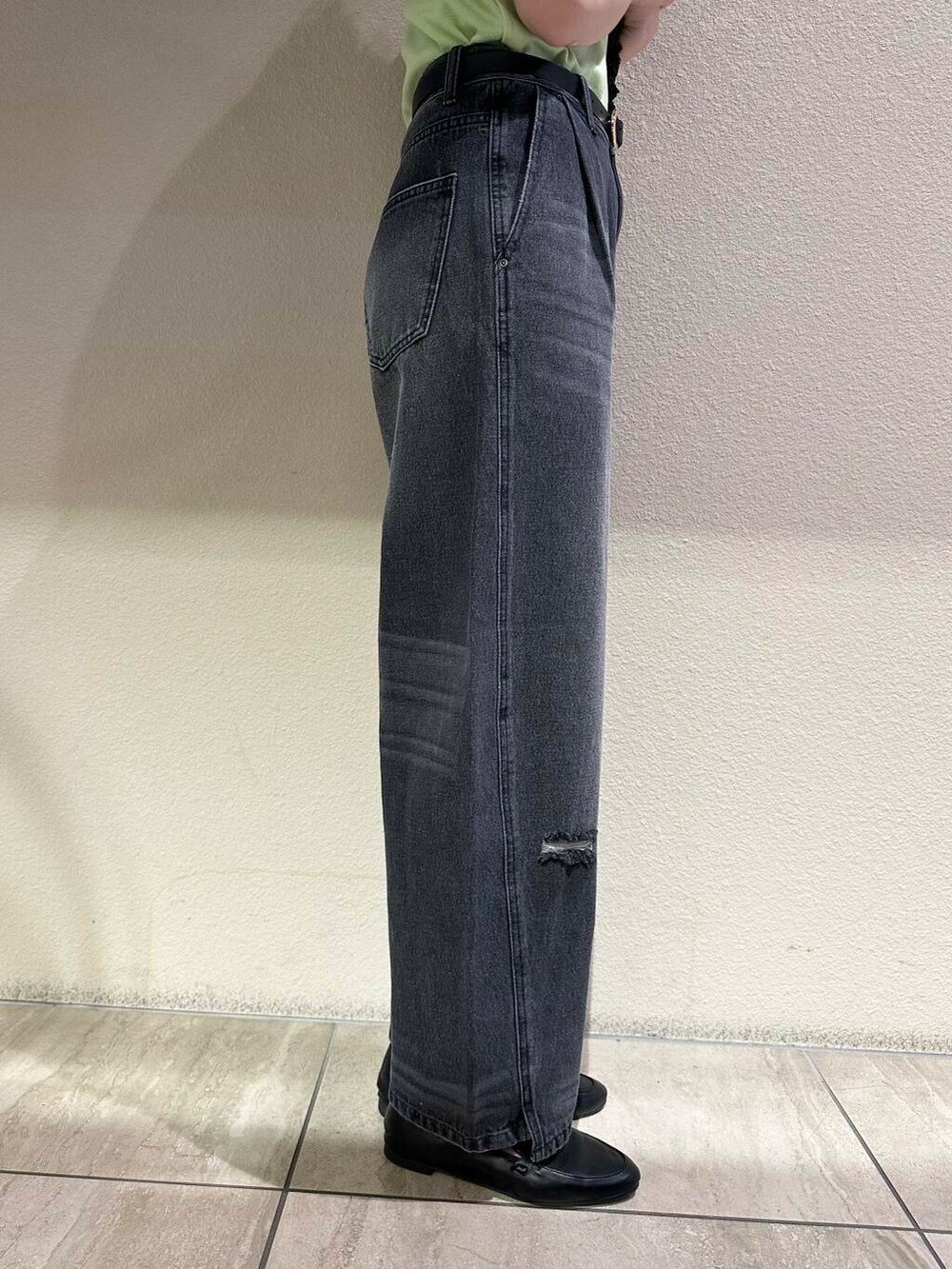 ブラック系のローファー、グリーン系のニット/セーター、グレー系のデニムパンツを着用したレディースの夏コーディネートの5枚目の写真