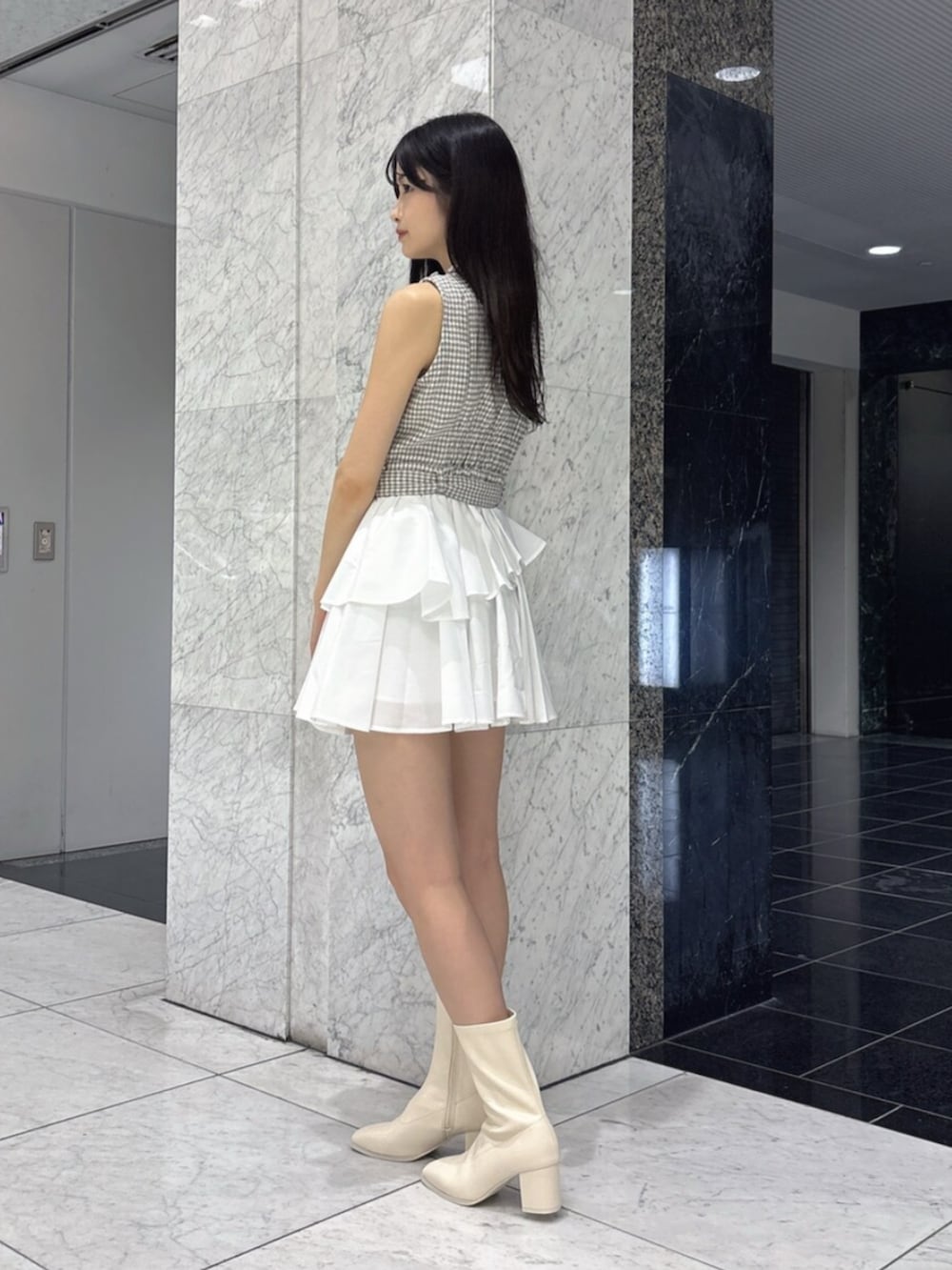 グレー系のワンピース、ホワイト系のブーツを着用したレディースの夏コーディネートの3枚目の写真